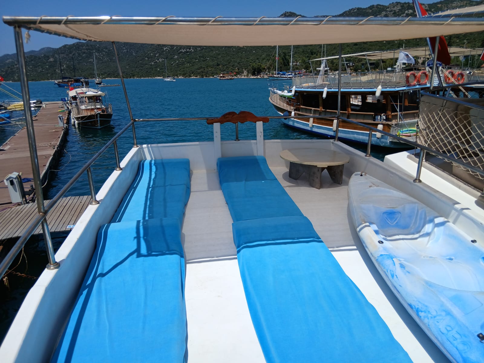 Sun mattresses and canoe on the upper deck, moored at Ucagiz